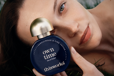 A person holds a bottle of own time to their face