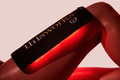 A person wears a red light body wrap on their chest