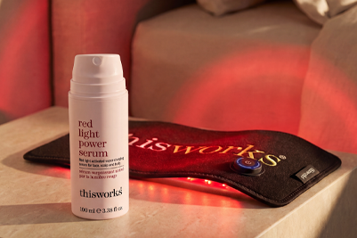 a bottle of red light power serum sits in front of the red light body wrap